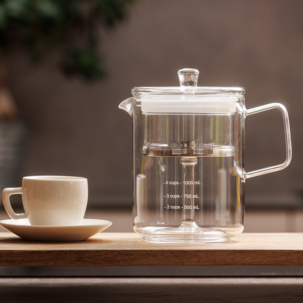 A retro inspired glass coffee percolator on a table ready to brew percolated coffee