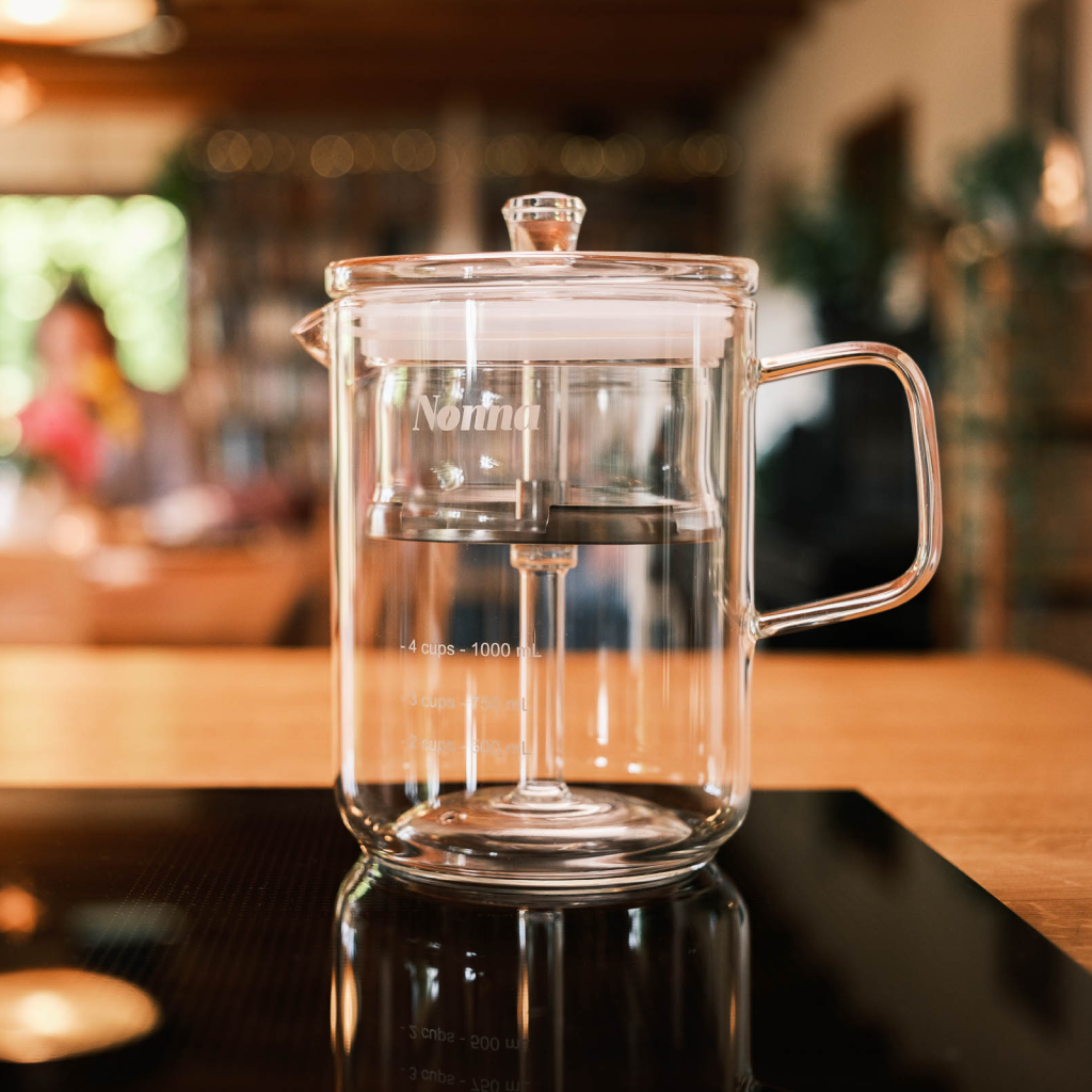 A retro inspired glass coffee percolator on a table ready to brew percolated coffee
